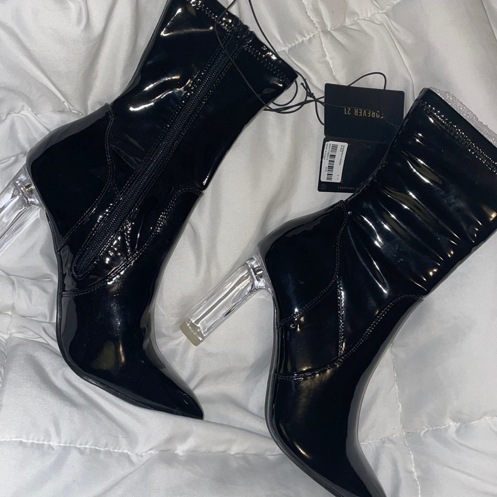 Never been worn. Black leather boots with clear heal.
